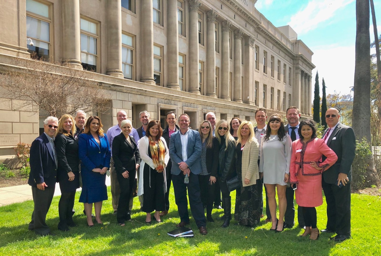 Holly with the founding member class of Certified Divorce Real Estate Experts outside a courthouse building