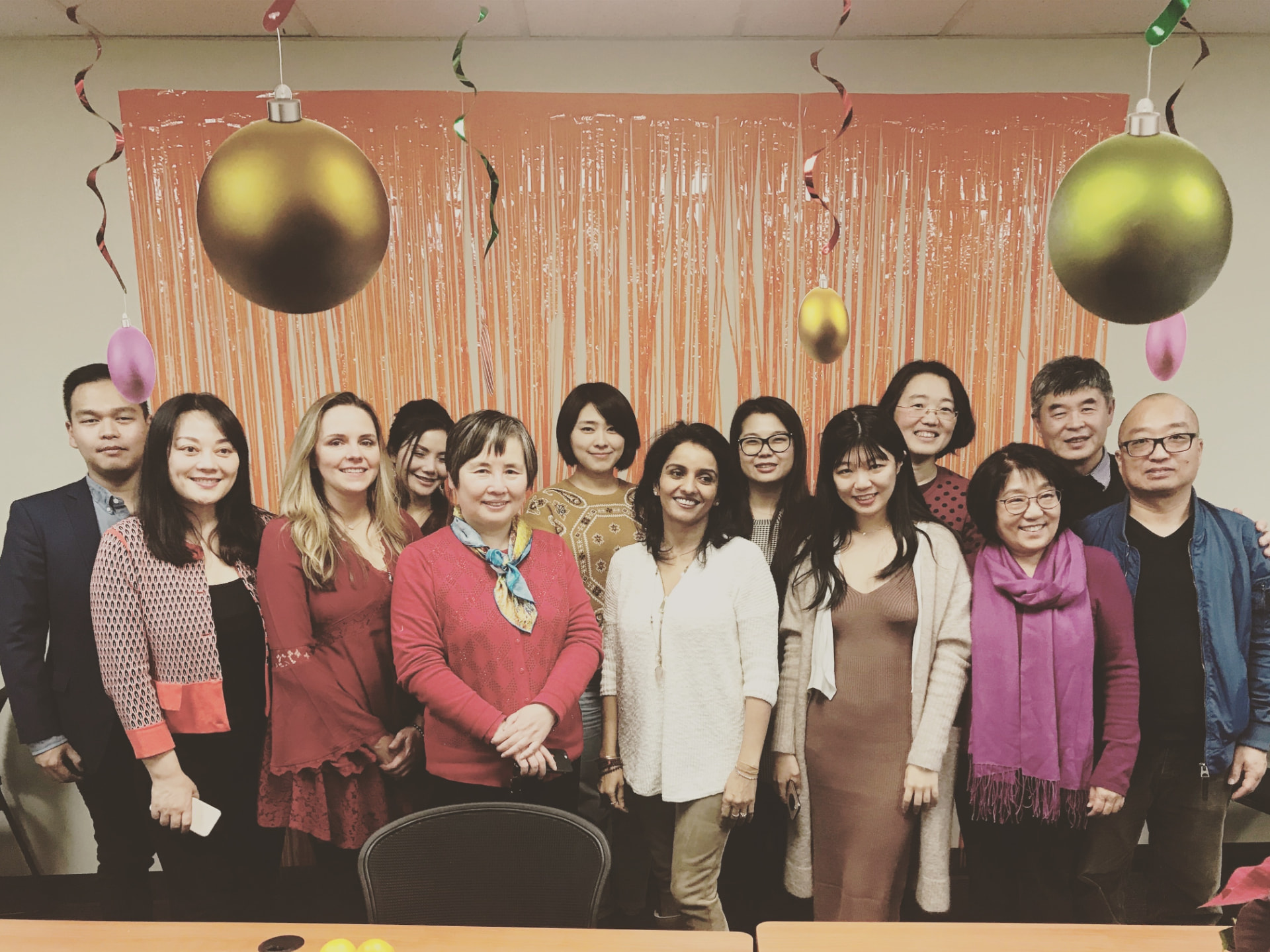 Holly with the relocation team she oversaw as Director of Relocation, standing together in a festively decorated office